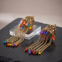 Antique gold carved jhumka earrings with long multi-color bead tassel chains by Trivo Essentials
