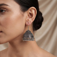 Antique oxidized silver jhumka earrings with textured dome and metallic bead drop details by Trivo Essentials
