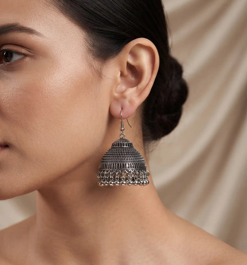 Antique oxidized silver jhumka earrings with textured dome and metallic bead drop details by Trivo Essentials