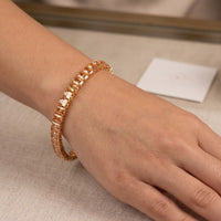 Gold plated tennis bracelet featuring rectangle emerald-cut champagne topaz CZ stones by Trivo Essentials