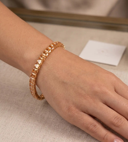 Gold plated tennis bracelet featuring rectangle emerald-cut champagne topaz CZ stones by Trivo Essentials