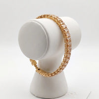Gold plated tennis bracelet featuring rectangle emerald-cut champagne topaz CZ stones by Trivo Essentials