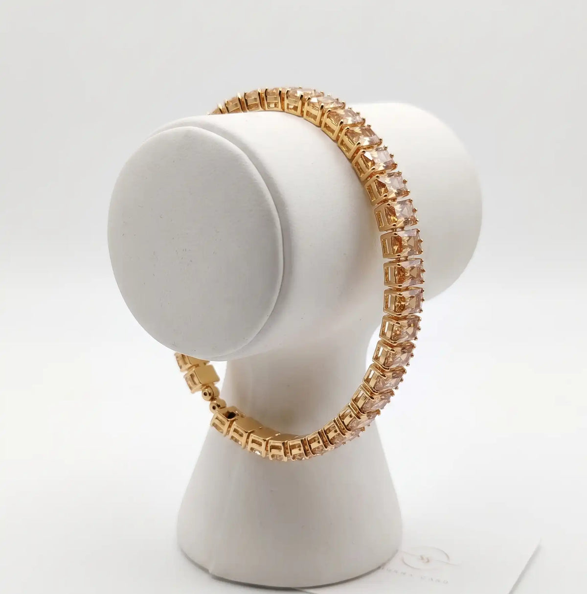 Gold plated tennis bracelet featuring rectangle emerald-cut champagne topaz CZ stones by Trivo Essentials