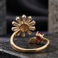 Gold plated adjustable sunflower ring featuring baguette zircons and pear cut ruby red stone accent by Trivo Essentials