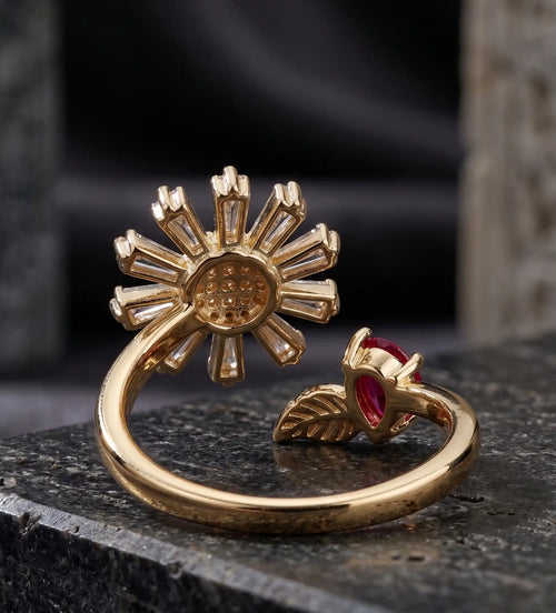 Gold plated adjustable sunflower ring featuring baguette zircons and pear cut ruby red stone accent by Trivo Essentials
