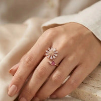Gold plated adjustable sunflower ring featuring baguette zircons and pear cut ruby red stone accent by Trivo Essentials