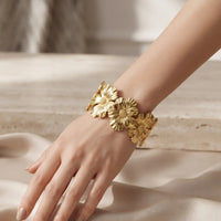 Gold plated open cuff bracelet kara featuring textured flower motifs by Trivo Essentials