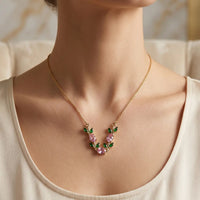 Gold plated floral vine necklace with pink zircon and emerald green leaves for women by Trivo Essentials