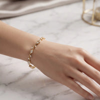 Gold plated tulip bracelet with brilliant clear oval crystals and leaf accents by Trivo Essentials