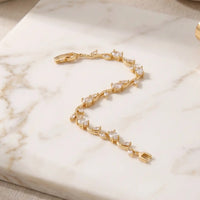 Gold plated tulip bracelet with brilliant clear oval crystals and leaf accents by Trivo Essentials