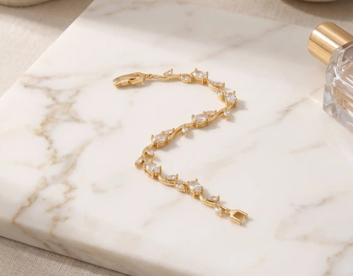 Gold plated tulip bracelet with brilliant clear oval crystals and leaf accents by Trivo Essentials