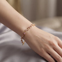 Gold plated tulip bracelet featuring soft light pink oval gemstones and matching pink leaf accents by Trivo Essentials