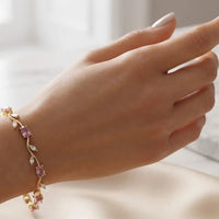 Gold plated tulip bracelet featuring oval blush pink stones and clear crystal leaf accents by Trivo Essentials