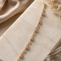 Gold plated tulip bracelet featuring oval blush pink stones and clear crystal leaf accents by Trivo Essentials