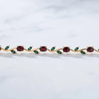 Gold plated tulip bracelet with oval ruby red stones and green marquise leaf gemstones by Trivo Essentials