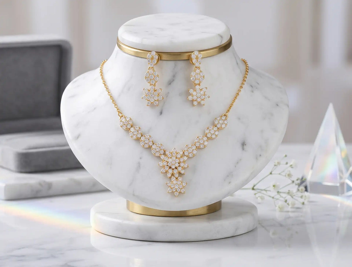 Gold plated floral zircon necklace set with matching dangle tops earrings on display stand by Trivo Essentials