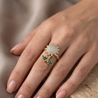 Gold plated adjustable rotating sunflower ring with pave white zircons and emerald green stone leaves by Trivo Essentials
