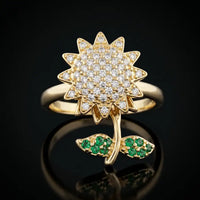 Gold plated adjustable rotating sunflower ring with pave white zircons and emerald green stone leaves by Trivo Essentials
