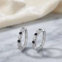 Rhodium silver huggie hoop earrings with alternating black and clear cubic zirconia stones by Trivo Essentials