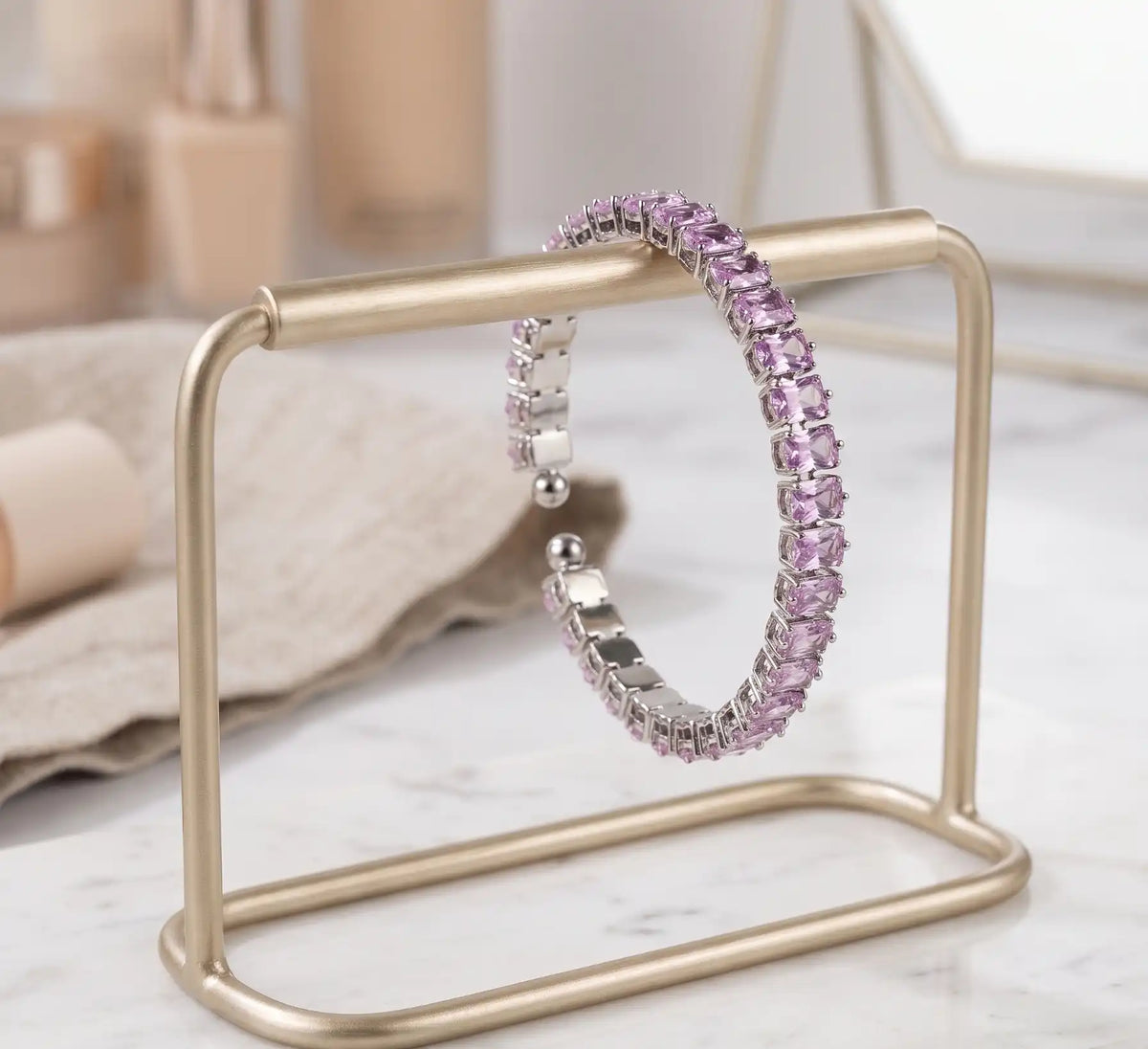 Rhodium silver plated tennis bracelet featuring rectangle emerald-cut soft pink CZ stones by Trivo Essentials