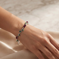 Rhodium silver plated tulip bracelet featuring oval ruby red stones and emerald green marquise leaves by Trivo Essentials