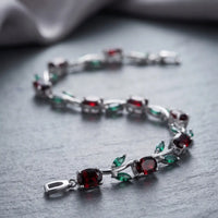 Rhodium silver plated tulip bracelet featuring oval ruby red stones and emerald green marquise leaves by Trivo Essentials