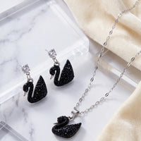 Silver plated black crystal swan pendant necklace and matching drop earrings set by Trivo Essentials