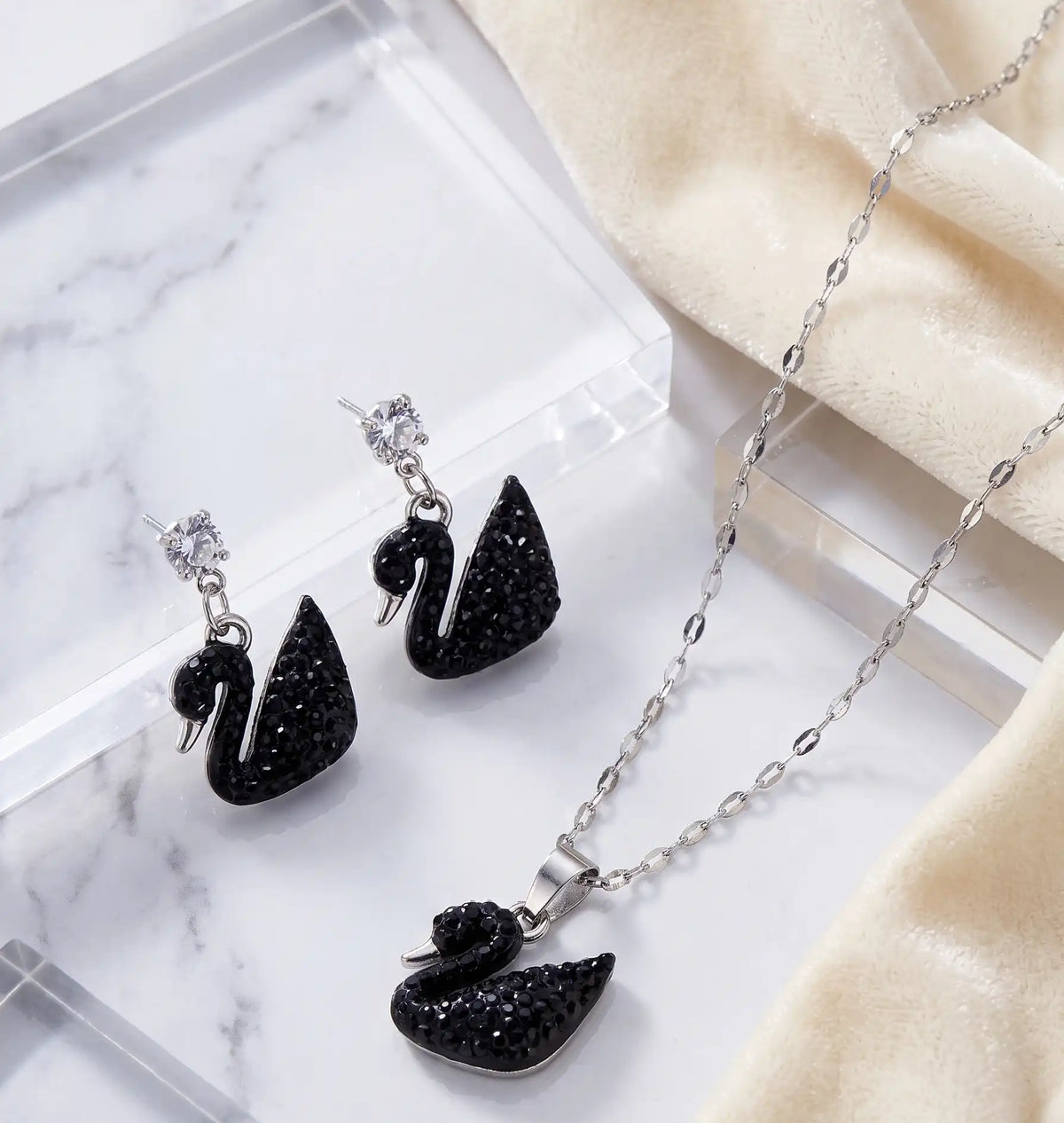 Silver plated black crystal swan pendant necklace and matching drop earrings set by Trivo Essentials