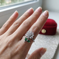 Silver plated adjustable spinning sunflower ring with pave white zircons and emerald green stone leaves by Trivo Essentials