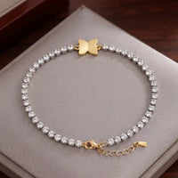 Two-tone silver and gold tennis bracelet with brilliant CZ crystals and a central butterfly charm by Trivo Essentials
