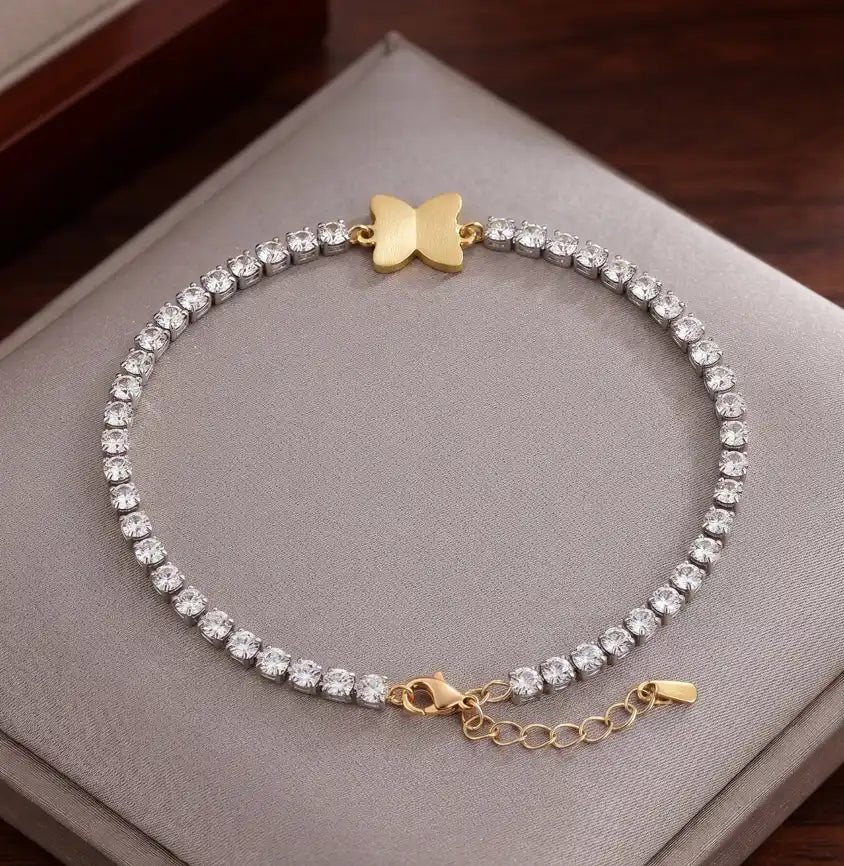 Two-tone silver and gold tennis bracelet with brilliant CZ crystals and a central butterfly charm by Trivo Essentials